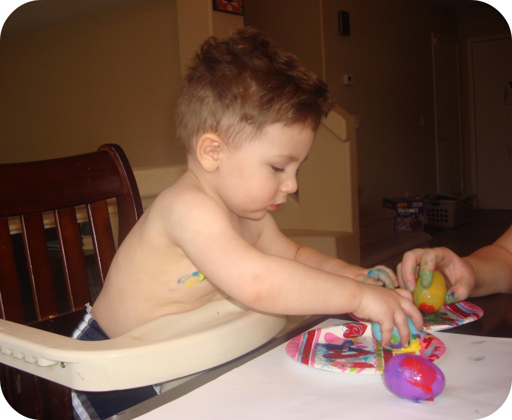 toddler fingerpainting eggs