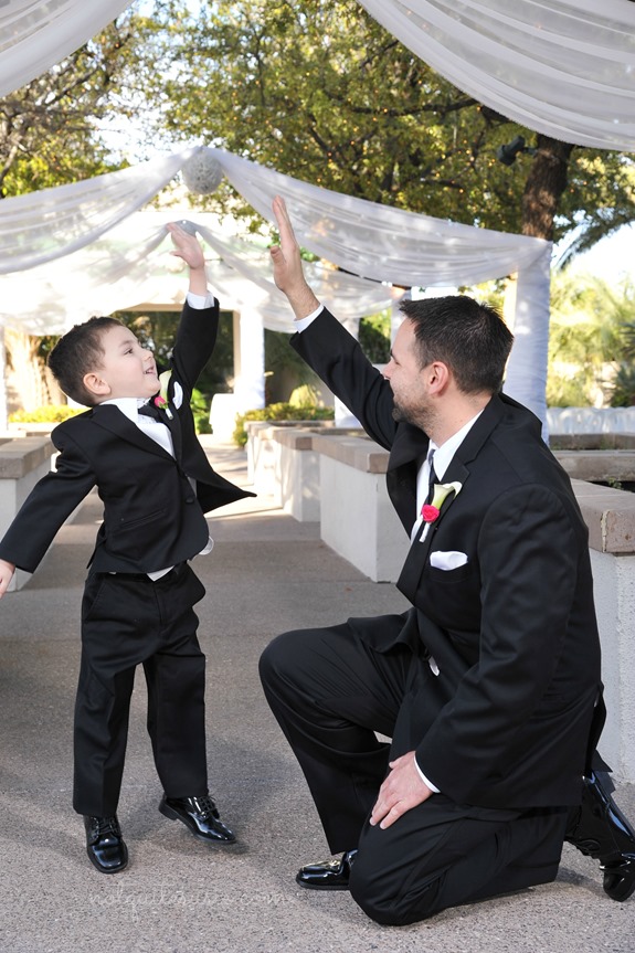 Dad and son high fiving at wedding