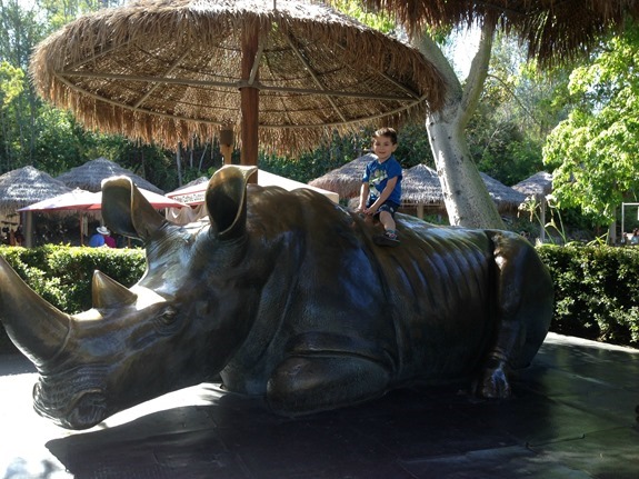 Shane posing on giant rhino statue at San Diego Zoo Safari Park