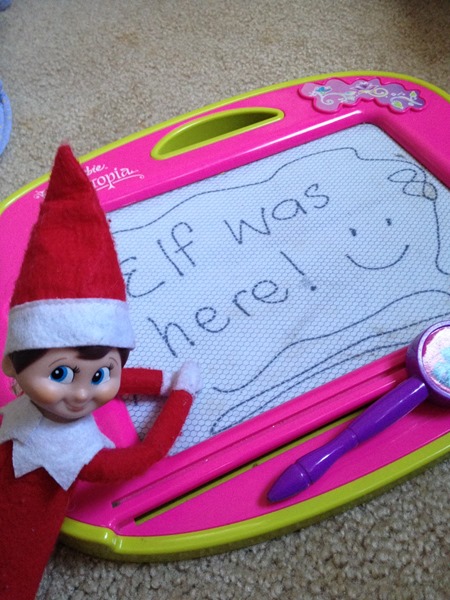 Elf on the Shelf leaving notes on magnadoodle