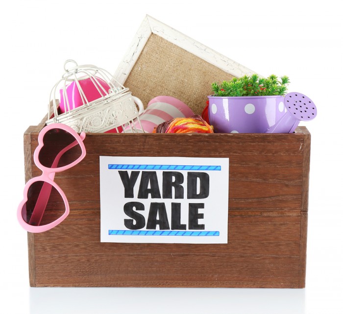 Box of unwanted stuff ready for yard sale isolated on white