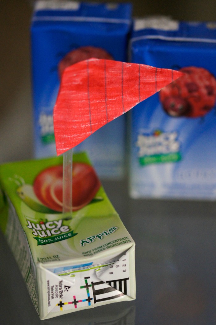 Looking for fun and free at home outdoor summer activities for kids? These DIY Juice Box Boats are a great way to take up an afternoon- build them by upcycling things from around the house and then set sail!