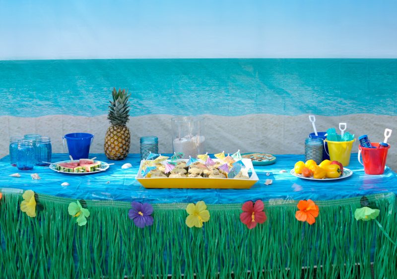 Need ideas for your Backyard Beach Theme Party? Whether you’re having a Hawaiian Luau birthday party or just celebrating summer with the kids, we’ve got you covered! From the mason jar decorations to the DIY beach ball Frisbee game to the beach cupcakes, we’re sharing all kinds of food, games, and décor ideas to make your party fun in the sun!