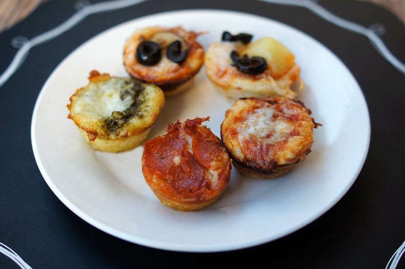 If you’re looking for a delicious, easy to customize appetizer for your next football party or tailgate, try these easy Mini Pizza Bites! You can add whatever toppings you like {think mushrooms, pepperoni, sausage, pineapple, bacon, olives- whatever!} and when you bake them in the Wilton Perfect Results Mega Muffin tin you get 48 of them per batch! That’s one way to win on game day! 