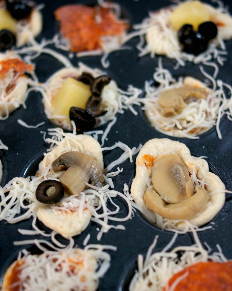If you’re looking for a delicious, easy to customize appetizer for your next football party or tailgate, try these easy Mini Pizza Bites! You can add whatever toppings you like {think mushrooms, pepperoni, sausage, pineapple, bacon, olives- whatever!} and when you bake them in the Wilton Perfect Results Mega Muffin tin you get 48 of them per batch! That’s one way to win on game day! 