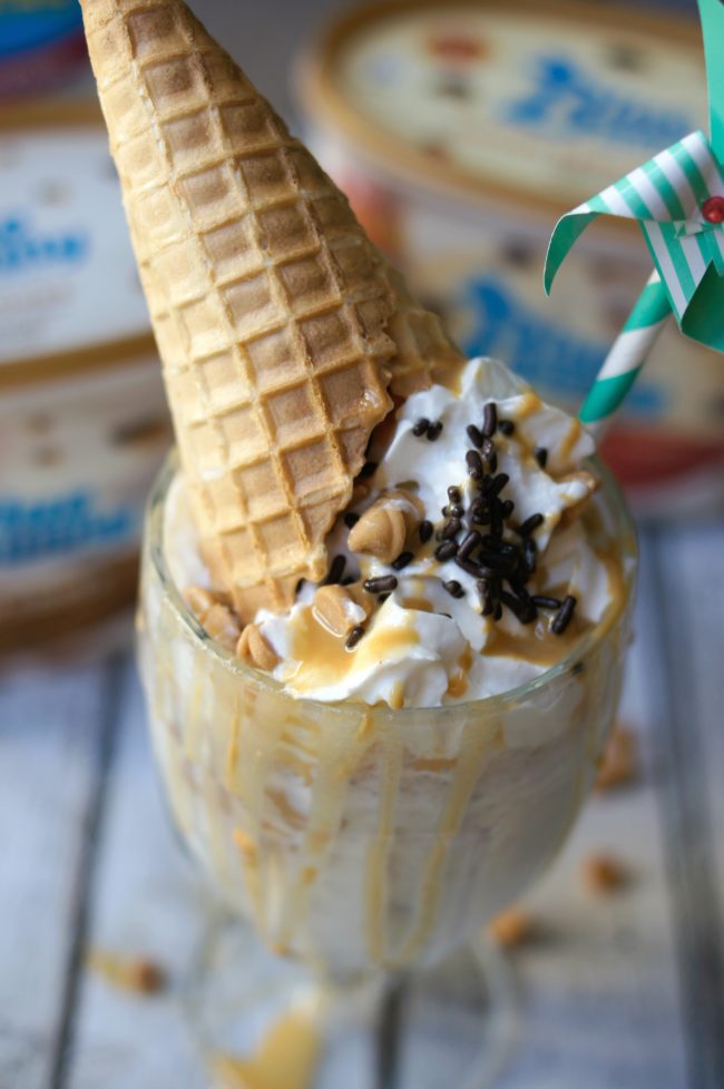 Have you ever had an extreme milkshake? They are popping up in restaurants around the world and each one of the ideas is more crazy than the next! Now you can DIY one at home, whether for parties or just desserts! This Extreme PB ‘N Cones Milkshake recipe is filled with peanut buttery goodness, a touch of chocolate sweets, and a real ice cream cone on top!