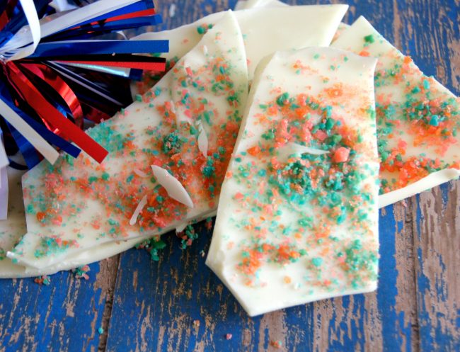 This easy 4th of July inspired red, white and blue candy bark recipe is so much fun to make- and even more fun to eat! This candy pops when you eat it for a fireworks show right in your mouth! You could use this idea for other holidays too, like birthday parties, Christmas, or even Halloween. Just pick any color from the rainbow for your chocolate and your candy!