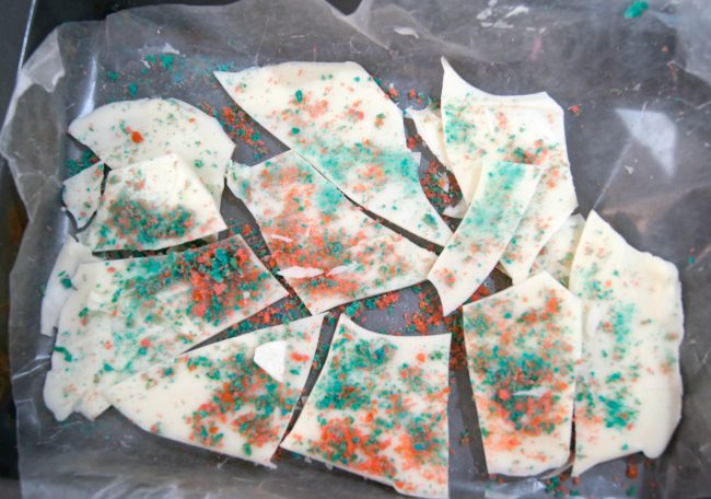 This easy 4th of July inspired red, white and blue candy bark recipe is so much fun to make- and even more fun to eat! This candy pops when you eat it for a fireworks show right in your mouth! You could use this idea for other holidays too, like birthday parties, Christmas, or even Halloween. Just pick any color from the rainbow for your chocolate and your candy!