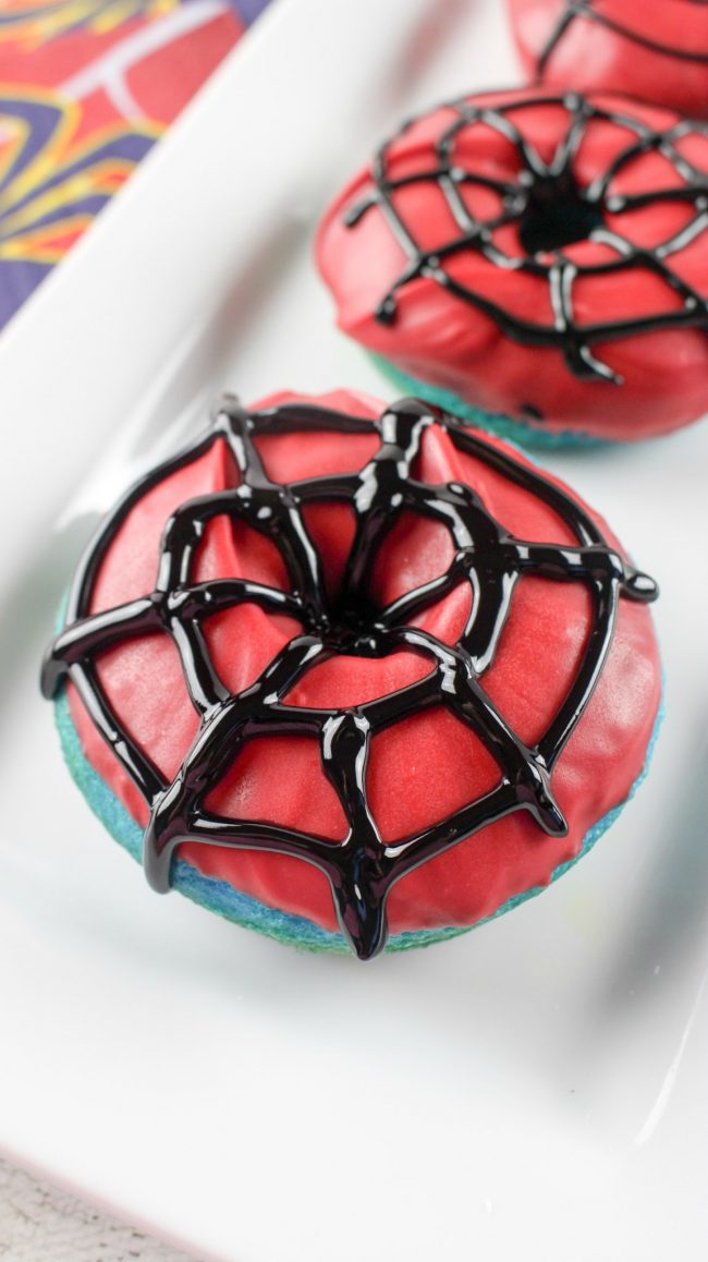 Have you seen the trailer for the new movie Spider-Man: Homecoming? It looks really good- and so funny! These DIY homemade Webslinger Donuts use cake mix and they’re baked, not fried, so they’re really easy to make. With the super cute Spider-Man icing, they would be the perfect breakfast recipe for after a birthday party sleepover or really any time!