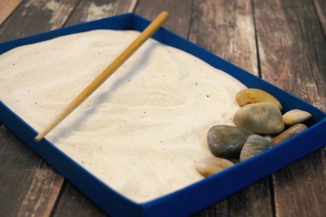 Zen gardens are beautiful places for meditation and to get new ideas- but not everyone has room in their backyard for a dedicated zen zone {not to mention the weather isn’t always cooperative!} Bring the zen garden indoors with this super easy upcycled craft idea! Make a miniature desktop DIY sand Zen Garden using mostly materials you have at home {this craft costs under $5 to make!} This project can even function as home décor and even as a fidget tool.