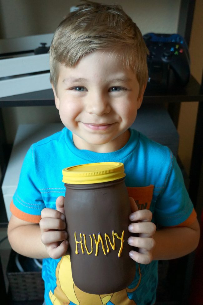 Winnie the Pooh is full of so many adorable characters and memorable quotes- and Disney’s Christopher Robin is sure to be the same! I can’t wait to visit the Hundred Acre Wood again and to celebrate, I made these adorable painted DIY mason jar vases featuring Winnie the Pooh and his Hunny Pot. You could use these vases for flowers, as a centerpiece for a baby shower, or as storage in the nursery for baby keepsakes! The vases can even be repurposed for older kids as bathroom storage!