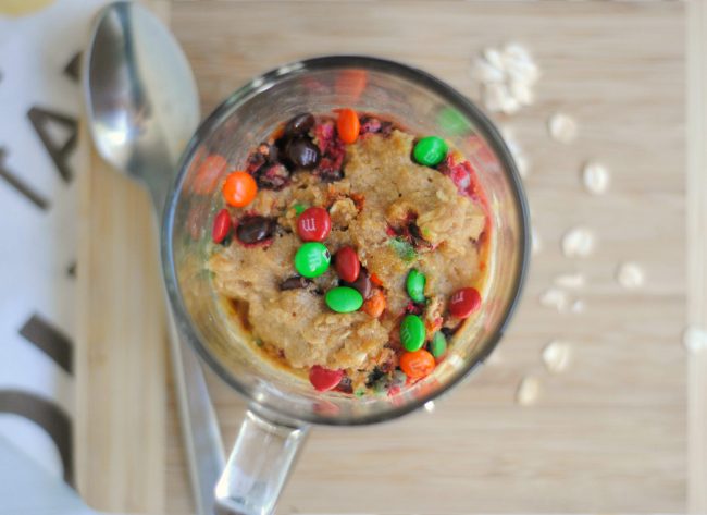 Is your sweet tooth craving something yummy? Try one of these super easy Monster Cookies! Make them with just a few ingredients- they take just one minute in the microwave and you can make them in your favorite cute mug! They have peanut butter {you can omit to make them peanut-free}, oats, and of course, M&M’s candy. 