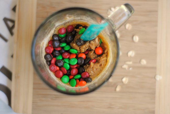 Is your sweet tooth craving something yummy? Try one of these super easy Monster Cookies! Make them with just a few ingredients- they take just one minute in the microwave and you can make them in your favorite cute mug! They have peanut butter {you can omit to make them peanut-free}, oats, and of course, M&M’s candy. 