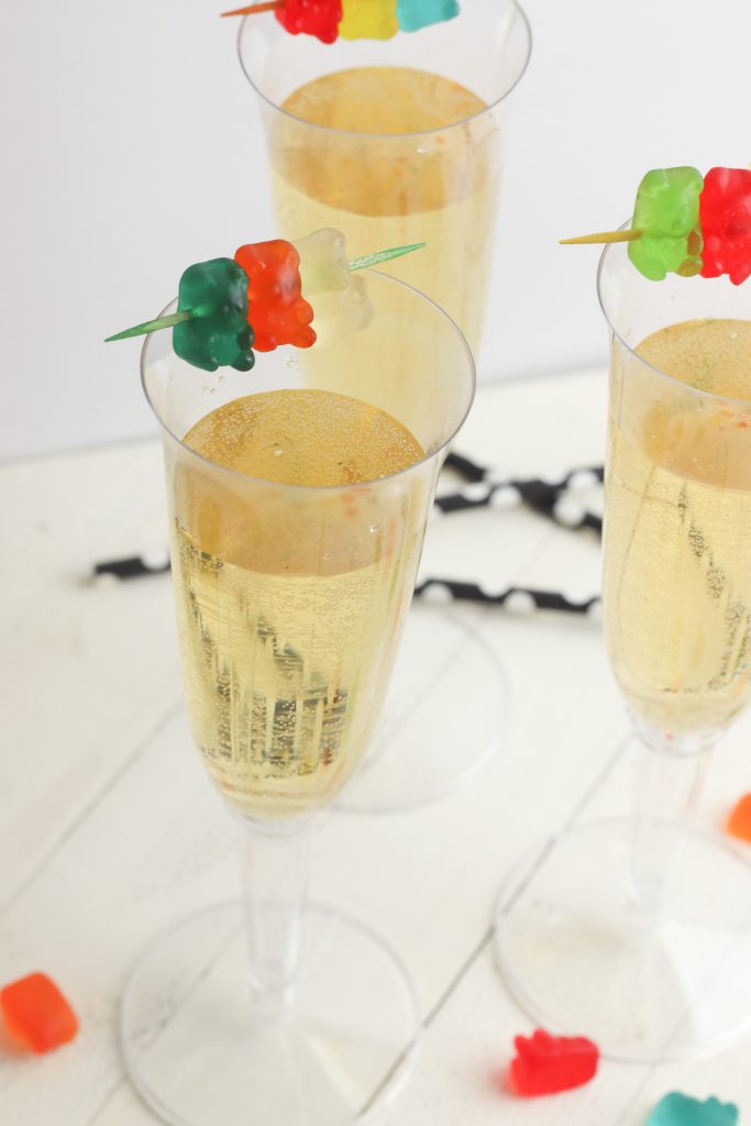 Need a non alcoholic kid friendly mocktail recipe for New Year’s Eve or other special celebrations? You won’t find one easier than this! With just two ingredients- three if you add the optional gummy bear garnish- you’ll ring in the New Year in style and celebrate!
