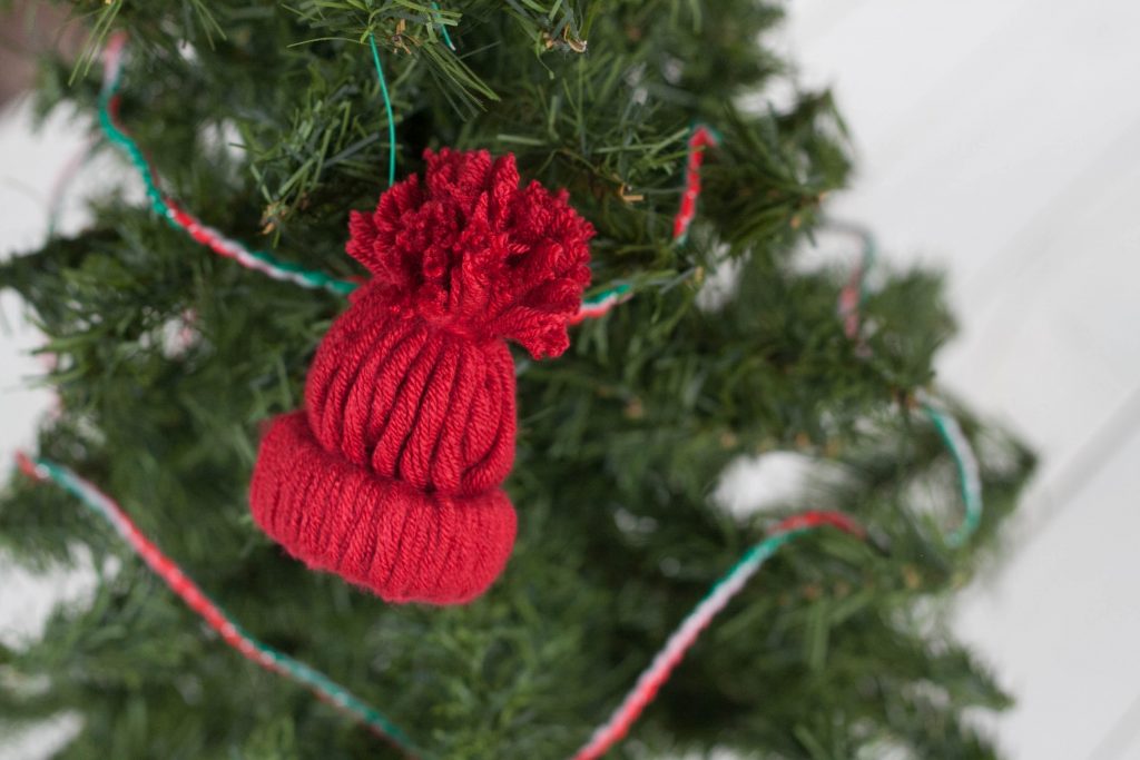 Love making unique and personalized handmade ornaments with your kids? This easy rustic DIY winter hat ornament is adorable and so fun to make for Christmas!