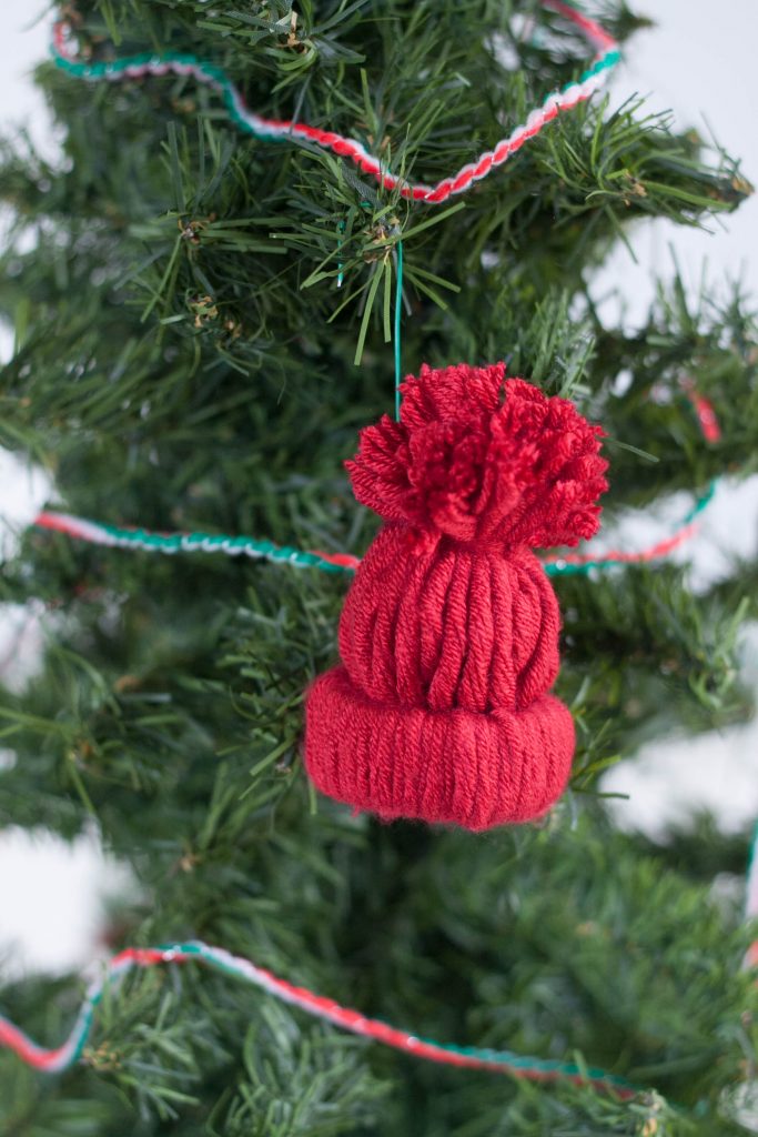 Love making unique and personalized handmade ornaments with your kids? This easy rustic DIY winter hat ornament is adorable and so fun to make for Christmas!