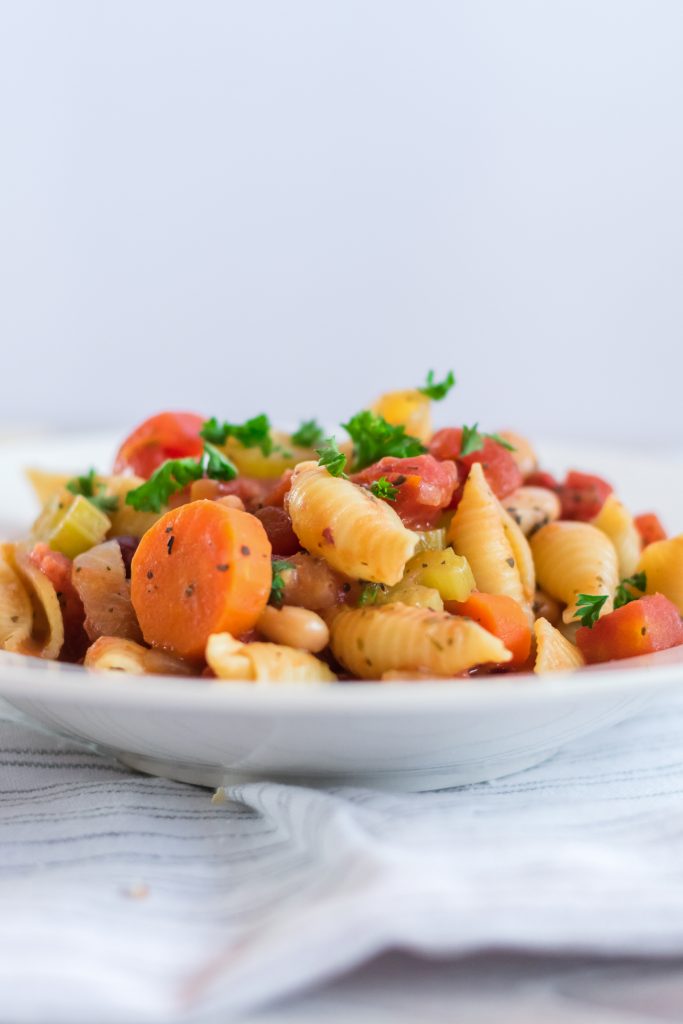 Need a new delicious, healthy vegetarian soup recipe? This Slow Cooker Minestrone Soup is so easy to make in your Crock Pot! It’s full of beans and vegetables for a healthy dinner and it makes enough to serve the whole family- with leftovers!