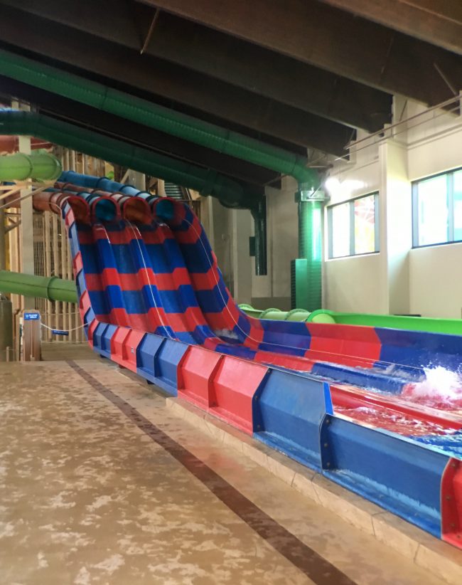 Red and white striped racing water slide at the Great Wolf Lodge Garden Grove indoor water park. Must Do Halloween Activities for Kids in Southern California: Great Wolf Lodge Garden Grove Howl-O-Ween